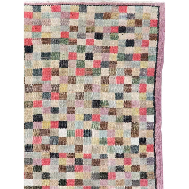 This mid-20th-century Turkish Anatolian accent rug presents an allover checkerboard composition formed from hundreds of...