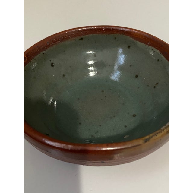 These are vintage studio pottery bowls featuring a dark blue glaze with variegated tones. It is designed for versatile use...