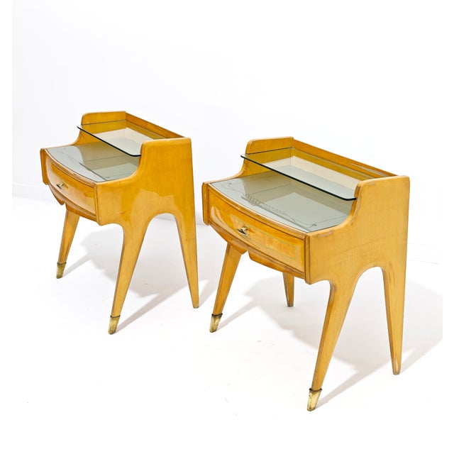 The design of this pair of 1950s nightstands reflects the aesthetic of prominent cabinetmakers and designers of the era,...