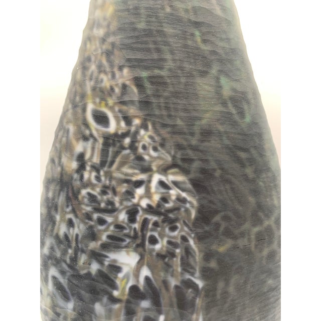 Crepax-designed artistic glass vase with a tapered and slightly asymmetrical shape, featuring a rounded body and tapered...