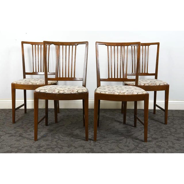 A good set of 4 Scandinavian / Danish Modern teak dining chairs. The chairs have a splay back with bannister type frame...