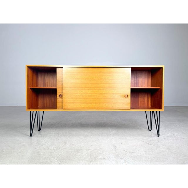 Beautiful vintage sideboard with two sliding doors from the 1960s/70s for sale. Thanks to its shallow depth, this piece of...
