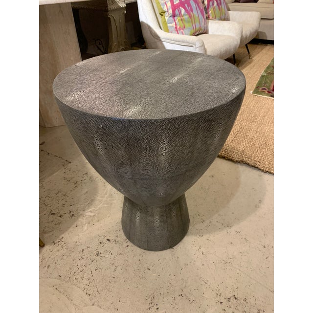 Great side table in a faux shagreen material. Perfect size next to sofa or between a pair of chairs. Interesting shape...