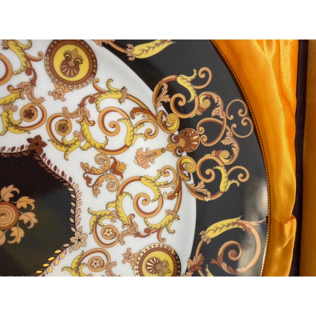 Versace designed large porcelain serving plate. Comes with its matching porcelain serving utensil and its original gold-...