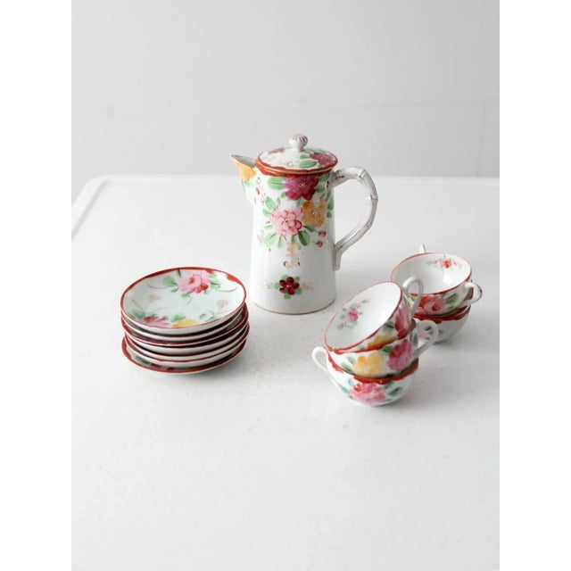 This is an antique Japanese tea set. The "eggshell" porcelain set includes a tea pot and six tea cups with saucers. A...