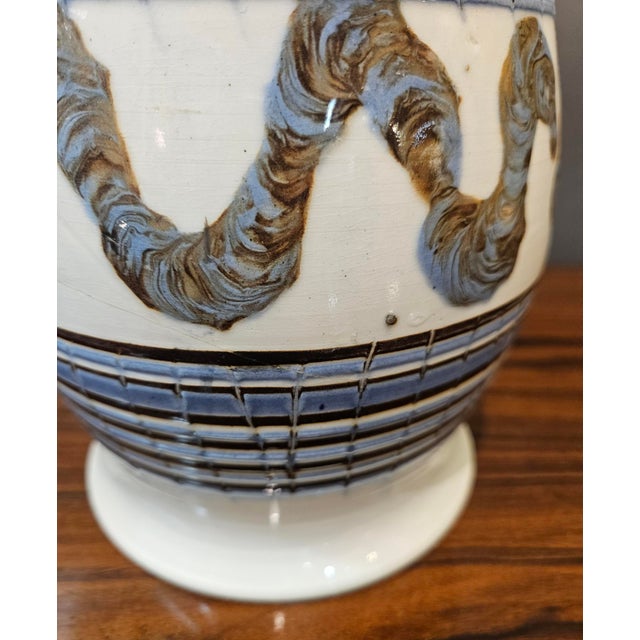 Elegant English Creamware Mocha Jug with 'Earthworm' Motif and Leaf Terminal Handle This remarkable English Creamware jug,...