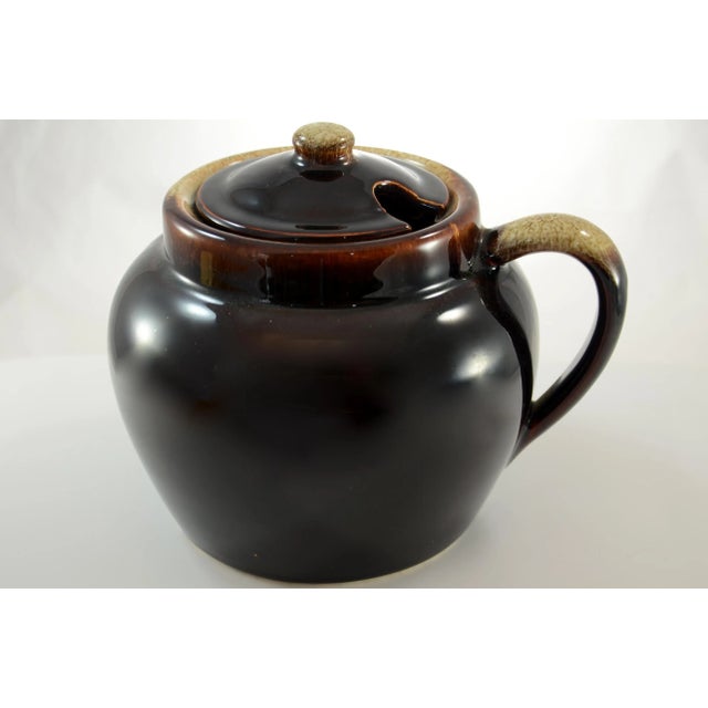 Large round vintage stoneware lidded bean or chili pot casserole crock with a single-handle in deep brown. Perfect in a...