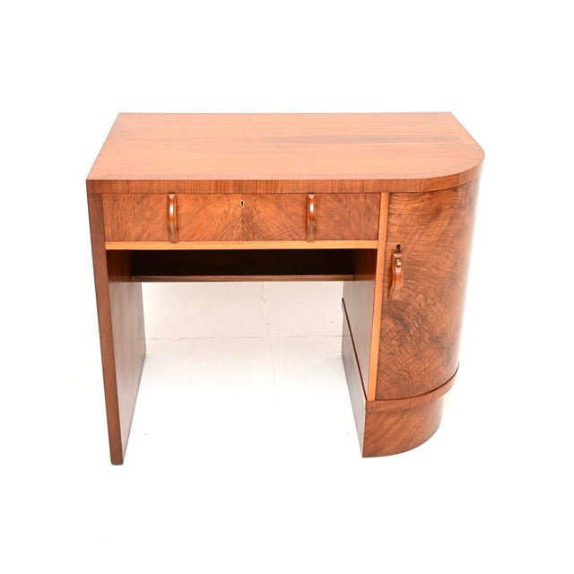 A stunning original Art Deco figured walnut desk. This was made in England, it dates from the 1930’s. It is an unusual...