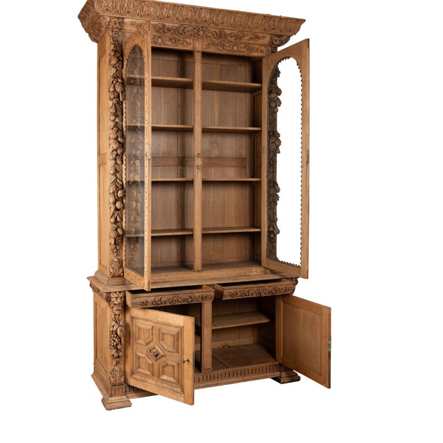 This tall oak bookcase is statuesque in size and detail. At over 9' tall, carved fruit, leaves, lion heads, flourishes and...