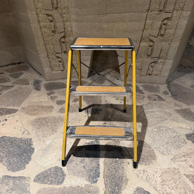 For your consideration, a vintage metal three-step folding utility ladder, often referred to as a pantry or kitchen step...