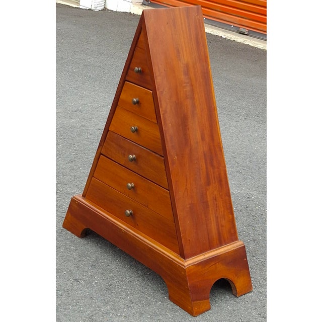 A vintage solid Teak pyramid chest of drawers. Features a unique triangular prism shape with graduated drawers and small...