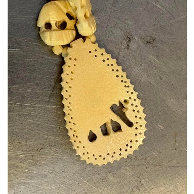 1920s-30s carved ivory or bone necklace w/ elephant pendant and screw clasp. Some yellowing to color throughout as shown....