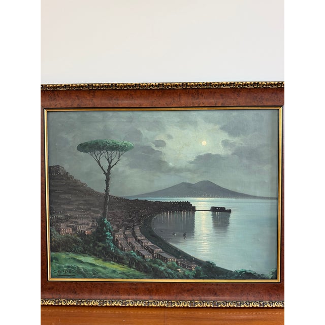 An atmospheric mid-century Italian oil on canvas by Carlo Ciappa, depicting a moonlit panorama of the Bay of Naples with...