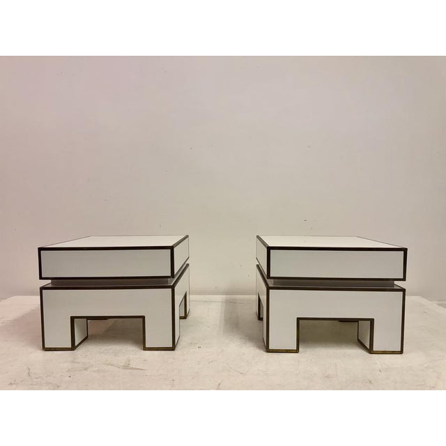 A pair of sculptural bedside tables by Alain Delon and produced by Maison Jansen. The design is characteristic of late...