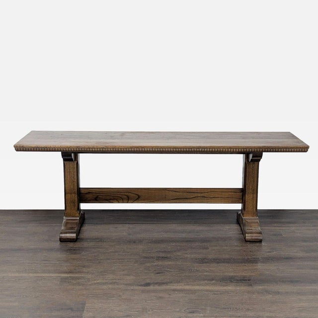 Oak trestle table resting on two pedestals. Brand: Cushman Classics by General Interiors. Dimensions (in): 84W x 24D x 30H.