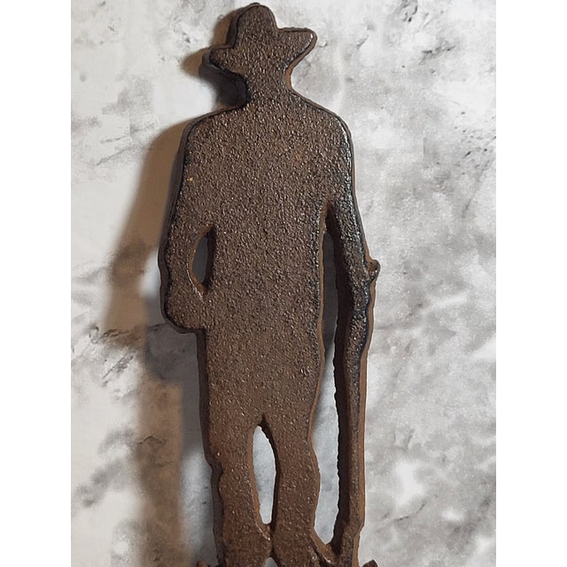 Vintage Cast Iron Cowboy/Hero Bottle Opener manufactured by John Wayne Enterprise from the 1950s. Sold as a Souvenir, the...