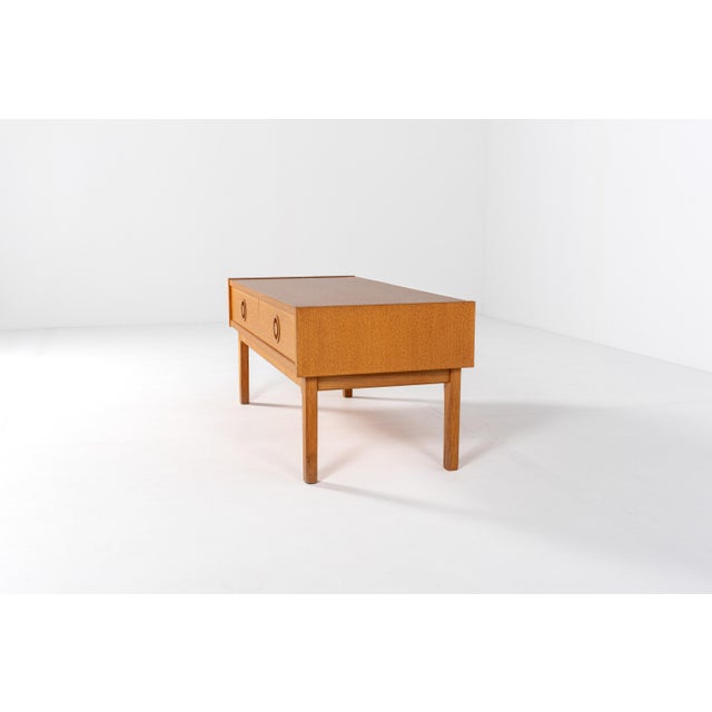 Danish mid-century low cabinet in oak veneer, dating from the 1960s. This elegant and minimal piece features two spacious...