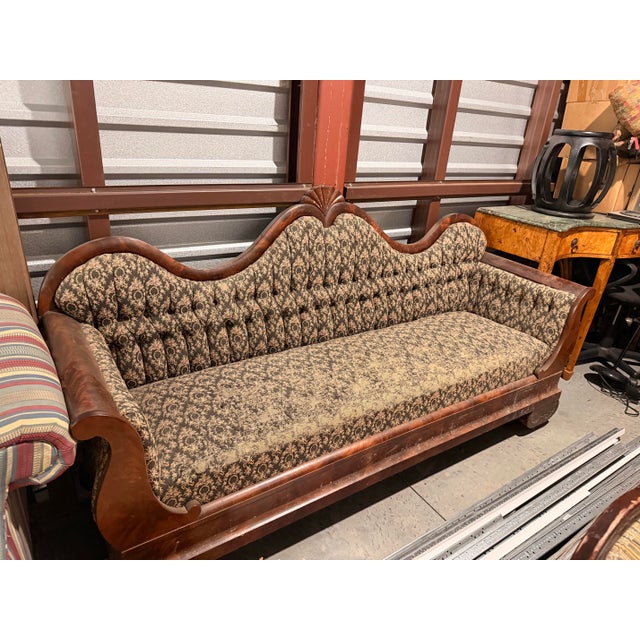 Victorian Era Sofa. Beautiful curved wood arms. Fabric in front needs replacing to make it your own. No photo of back,...