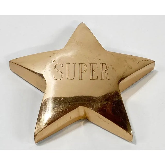 Nice sized vintage brass paper weight in the shape of a star with word SUPER engraved to top. Patina with some scratches...