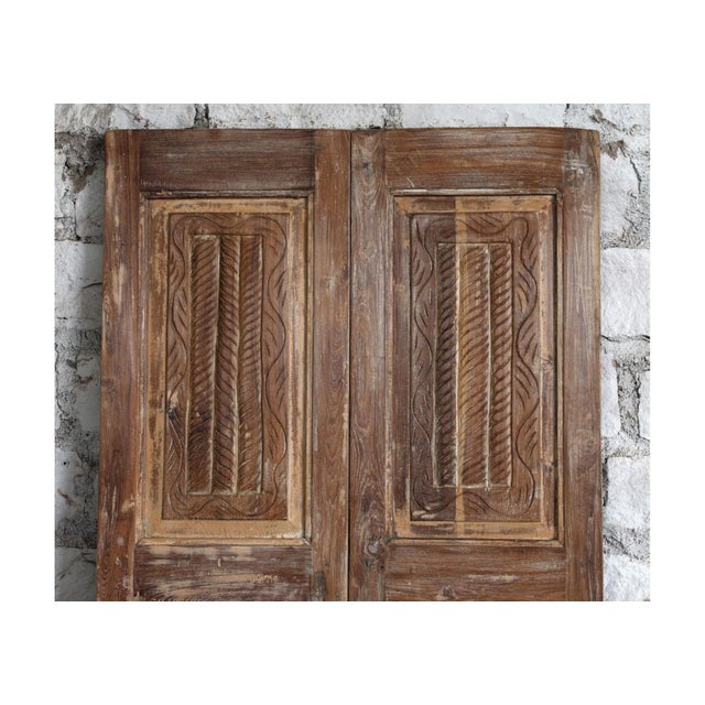 These antique floral carved double doors are a striking example of old-world craftsmanship, handcrafted from reclaimed...
