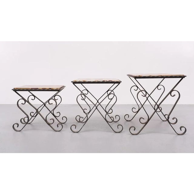 Wonderful set of three Mid Century Modern nesting tables. Striking French design from the seventies. Three Wrong Iron hand...
