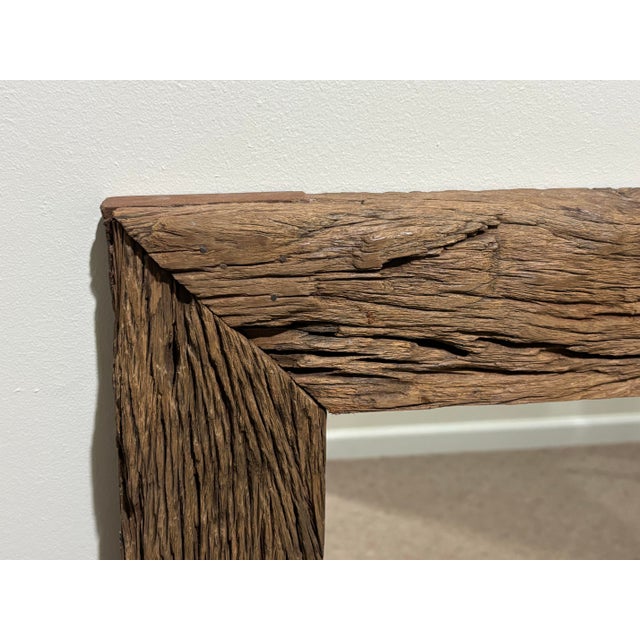 This is a beautiful wall mirror with an attractive rustic flair. It was made around 1990 and feature a thick wooden frame...