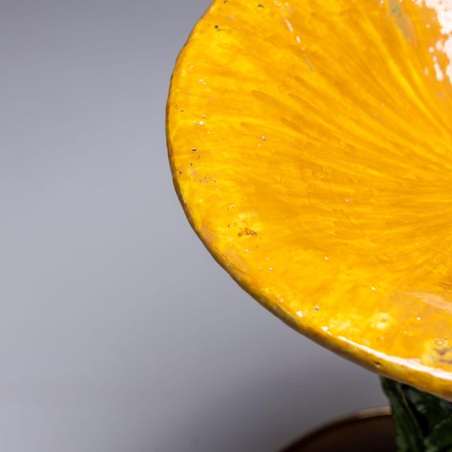 Italian ceramic side table from the 1960s, with a round glass tabletop. The table is made of green-yellow glazed ceramic...