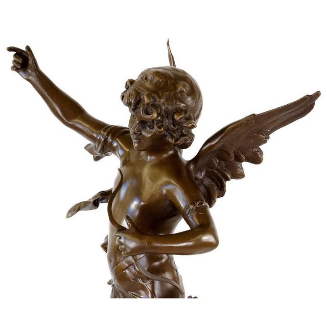 Patinated bronze angel sculpture, style of the 20th century. This bronze statue represents a winged angel standing on a...