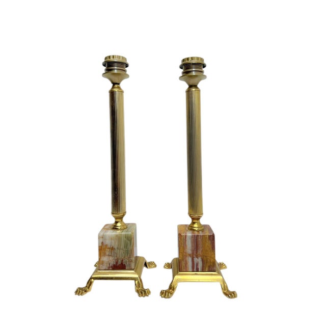 An elegant set of vintage French table lamps from the 1960s. The materials used are brass and onyx marble, and the design...