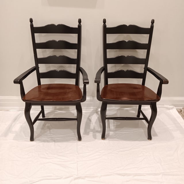 Vintage French Country Farmhouse Ladderback Arm Chairs, Set of 2 The chair frame is an ebony finish and the seat is a warm...