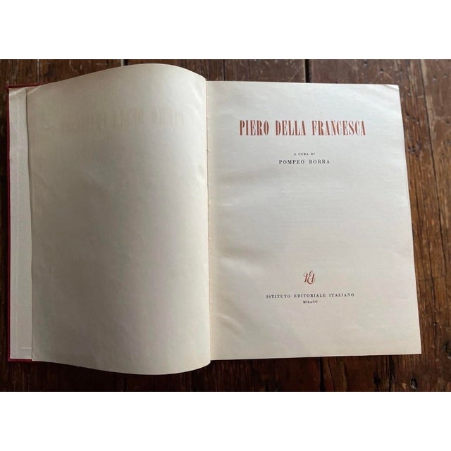 Offering a large hard cover vintage book Piero Della Francesca by Pompeo Borra. The large book measures 9 1/2" x 13" x 1...