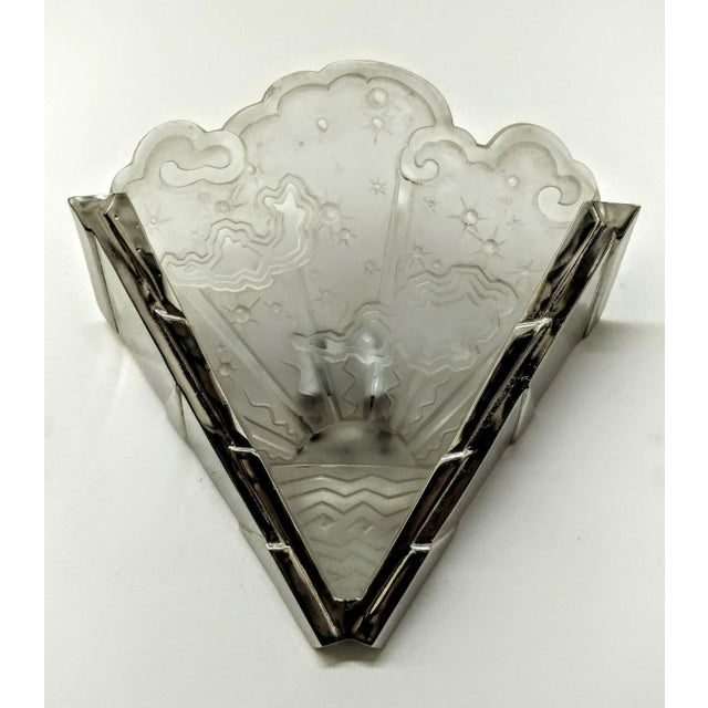 A pair of French Art Deco wall sconces by the French artist " Muller Ferers ". Molded clear frosted glass shades decorated...