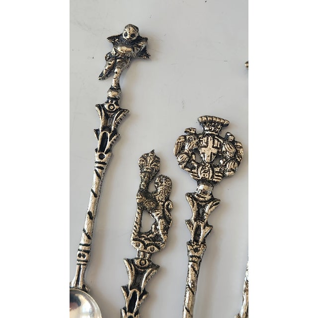 A charming set of mid-century Italian figural demitasse spoons, each cast with ornate architectural and heraldic motifs...