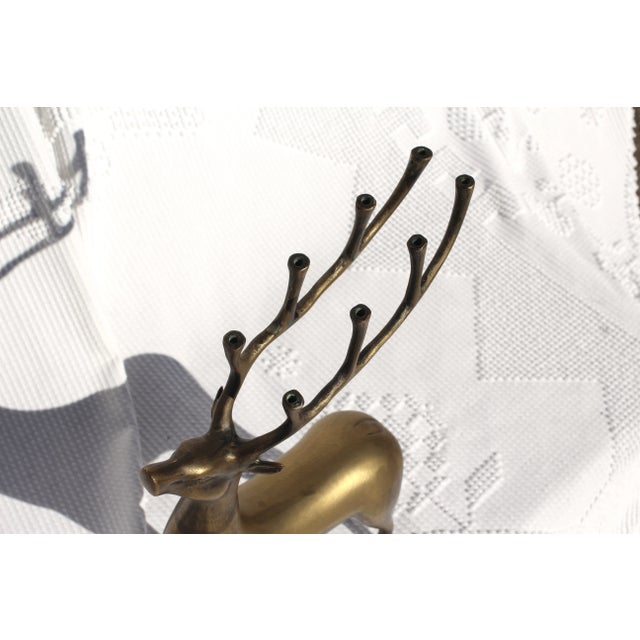 A larger brass deer with antlers that hold candles. Wonderful gold patina and a great size for a mantle. Heavy brass in...
