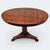This 19th-century English William IV Mahogany Tilt-Top Table with Pedestal Tri-Form Base is a quietly commanding piece...