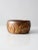 A vintage studio pottery bowl signed by the artist, featuring a warm brown glaze complemented by goldenrod accents. The...