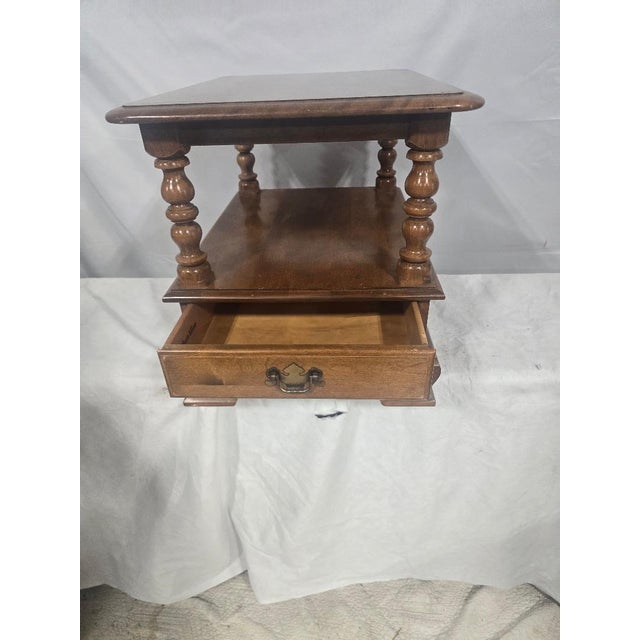 Classic Ethan Allen solid wood chairside table featuring turned spindle supports, a single storage drawer with original...