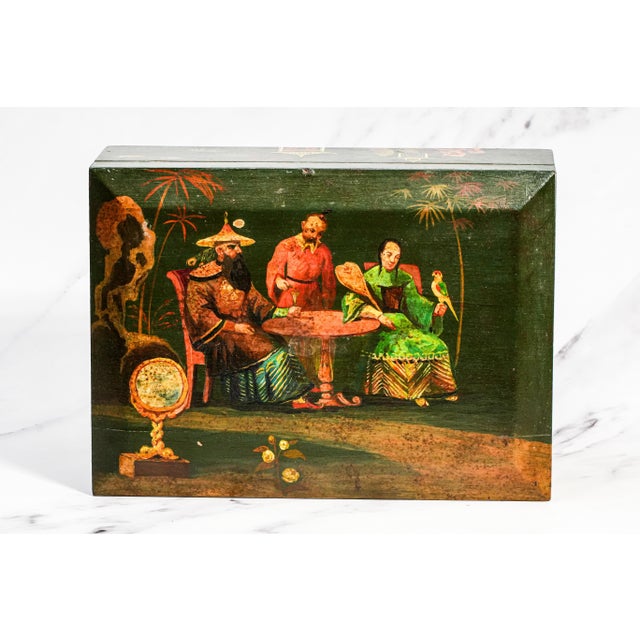 A captivating blend of artistry and function, this antique wooden humidor box showcases the timeless elegance of...