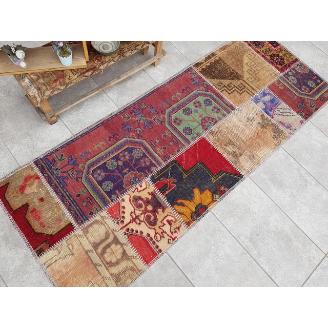 This is a vintage Turkish Oushak rug from the Mid 20th Century. The piece was hand-knotted.