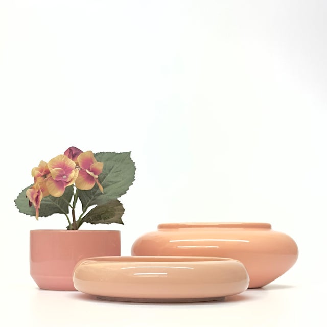 Blush pink ceramic planters, group of 3. This is a stunning and sleek set of blush pink and peach ceramic planters from...