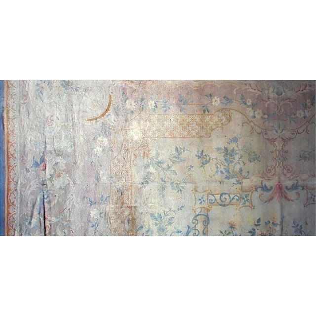 Evoking the opulent charm of early 20th-century French design, this exquisite antique Savonnerie rug, dating to the 1920s,...