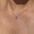 This floral pendant necklace features a 0.24 carat blue sapphire set in 14K white gold, measuring approximately 3.2 x 4.2...