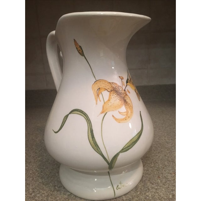 Absolutely lovely and vibrant ceramic hand-painted pitcher from Italy. A white background with hand-painted details of a...
