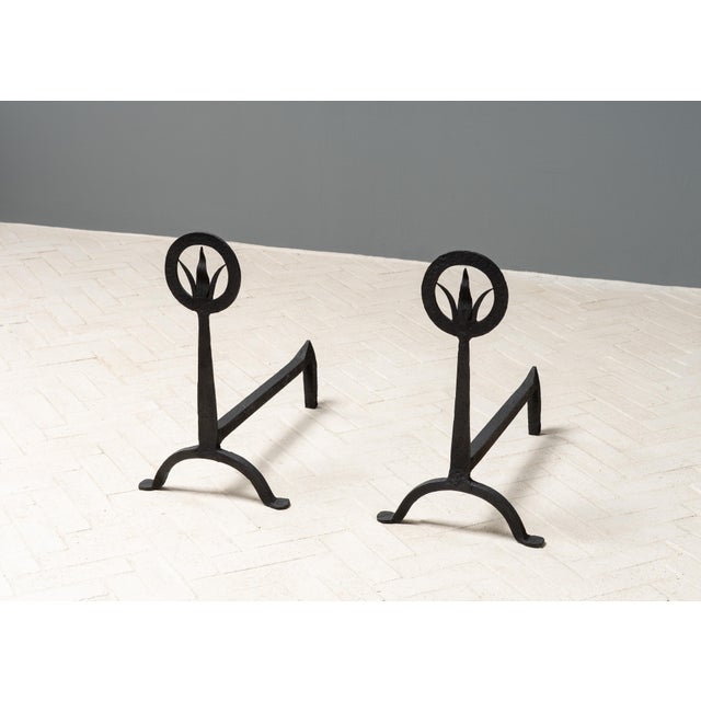 USA, ca. early 1900s. A handsome pair of hand forged Arts & Crafts andirons. Each features hammered iron construction with...