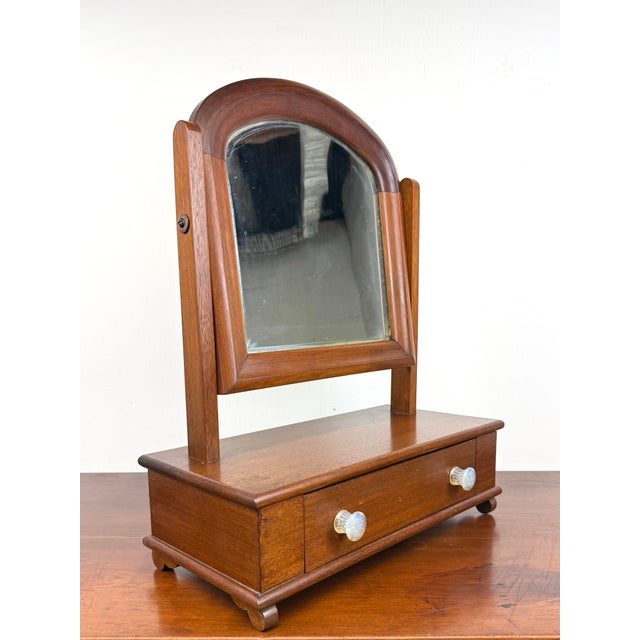 A mid to late 19th century table top tilting shaving / vanity mirror with dovetailed drawer in base. Features beautiful...