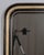 A 19th century French Louis Philippe mirror with curved top corners, black painted and gilt finish with subtle incised...