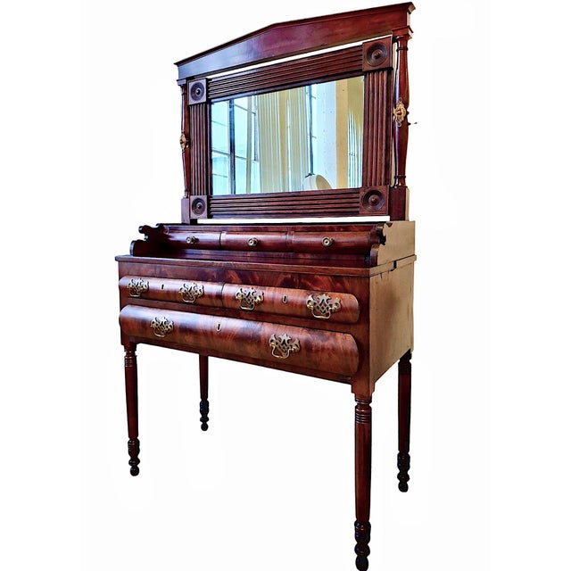 This handsome piece is an authentic American Empire style dressing table or vanity, dating from the 1830s to the 1840s....