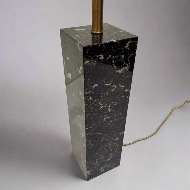 A Modernist black marble column table lamp from USA circa 1950. Rectangular solid marble form and patinated brass details....