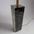 A Modernist black marble column table lamp from USA circa 1950. Rectangular solid marble form and patinated brass details....