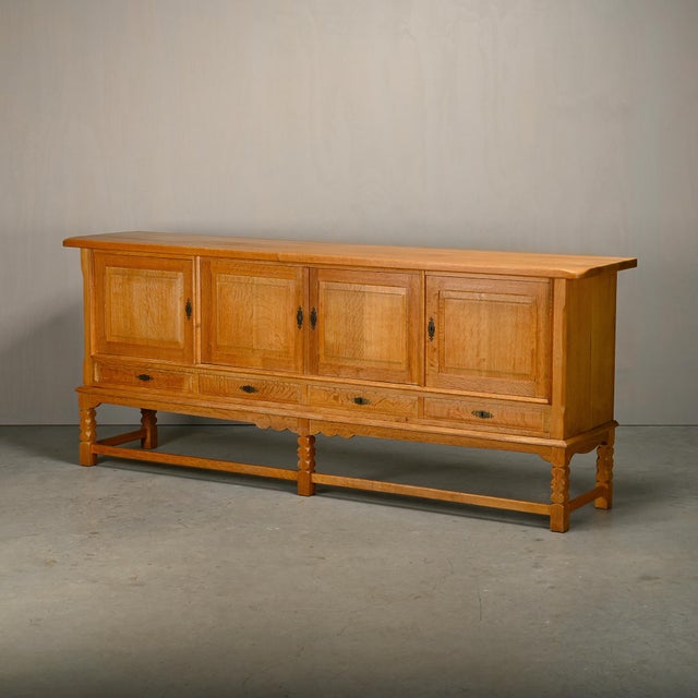 Large Mid-Century Brutalist Sideboard designed by Henning (Henry) Kjærnulf, 1960s. This well-proportioned sideboard is a...